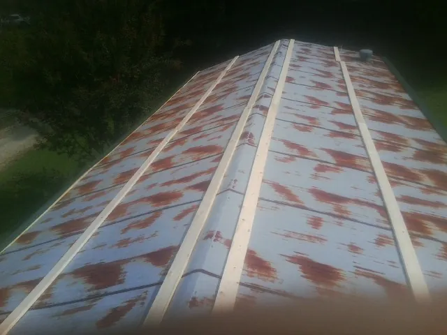 Rusted metal roof panels with new wood purlins before replacement — Storm Damage Roof Repair in Cygnet by Roofing Brothers